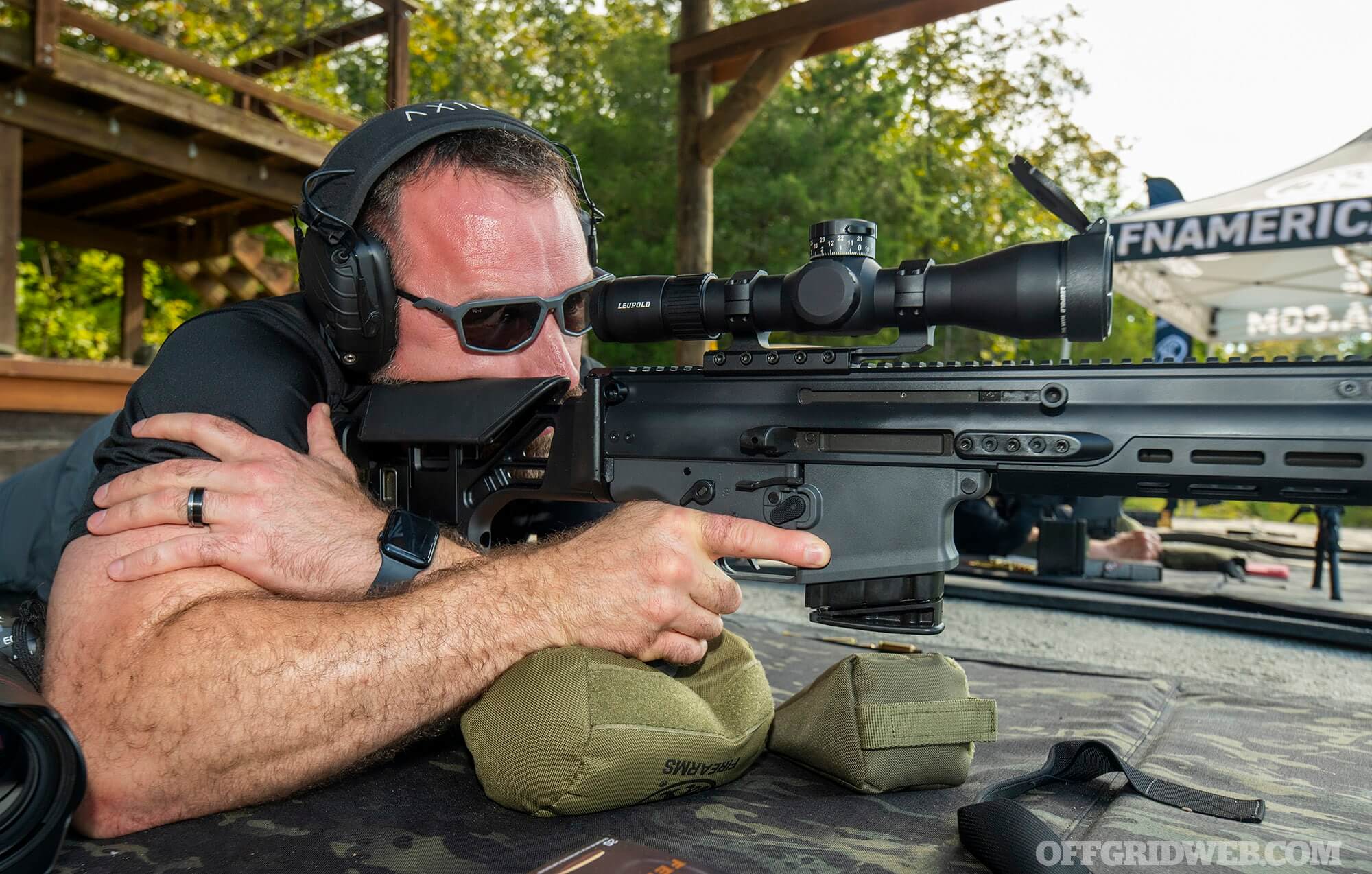 Vibrant SHOT Show 2026 exhibit hall packed with booths showcasing new firearms, attendees testing gear, and massive displays of rifles and pistols.