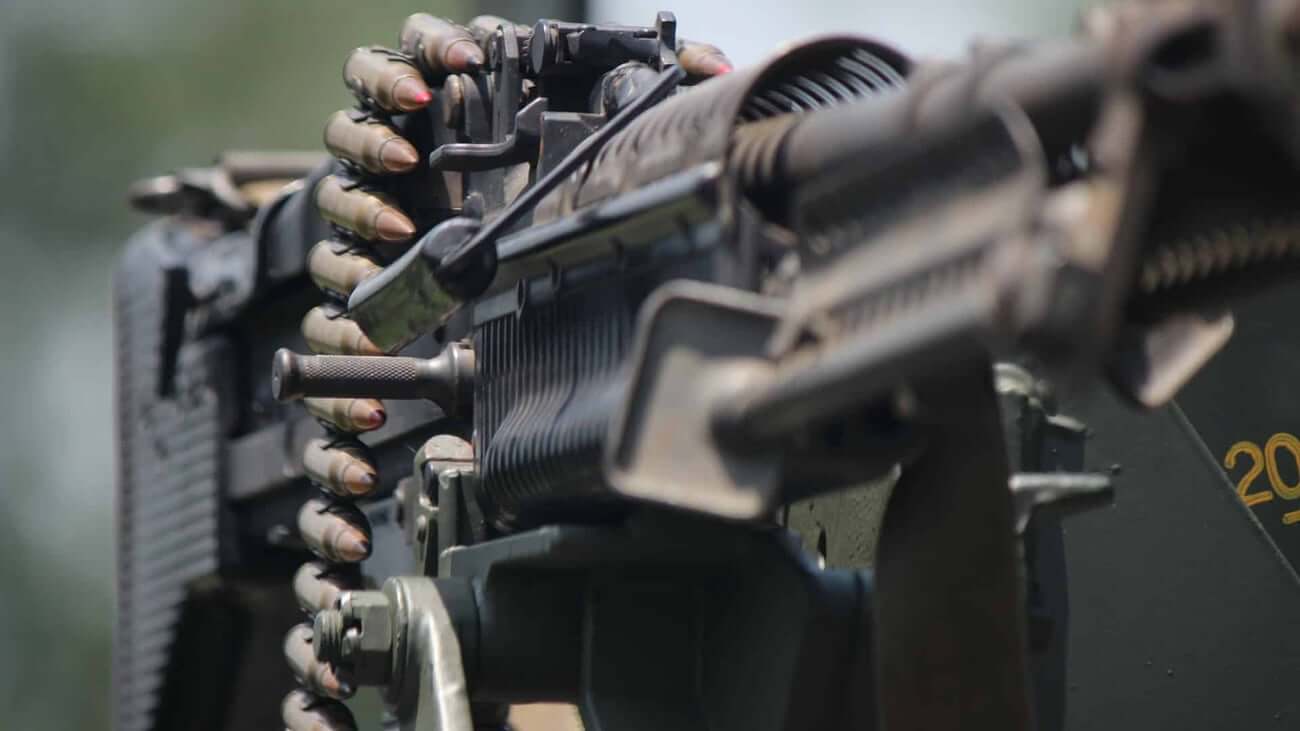 Gavel striking down on a machine gun silhouette with Second Amendment text overlay