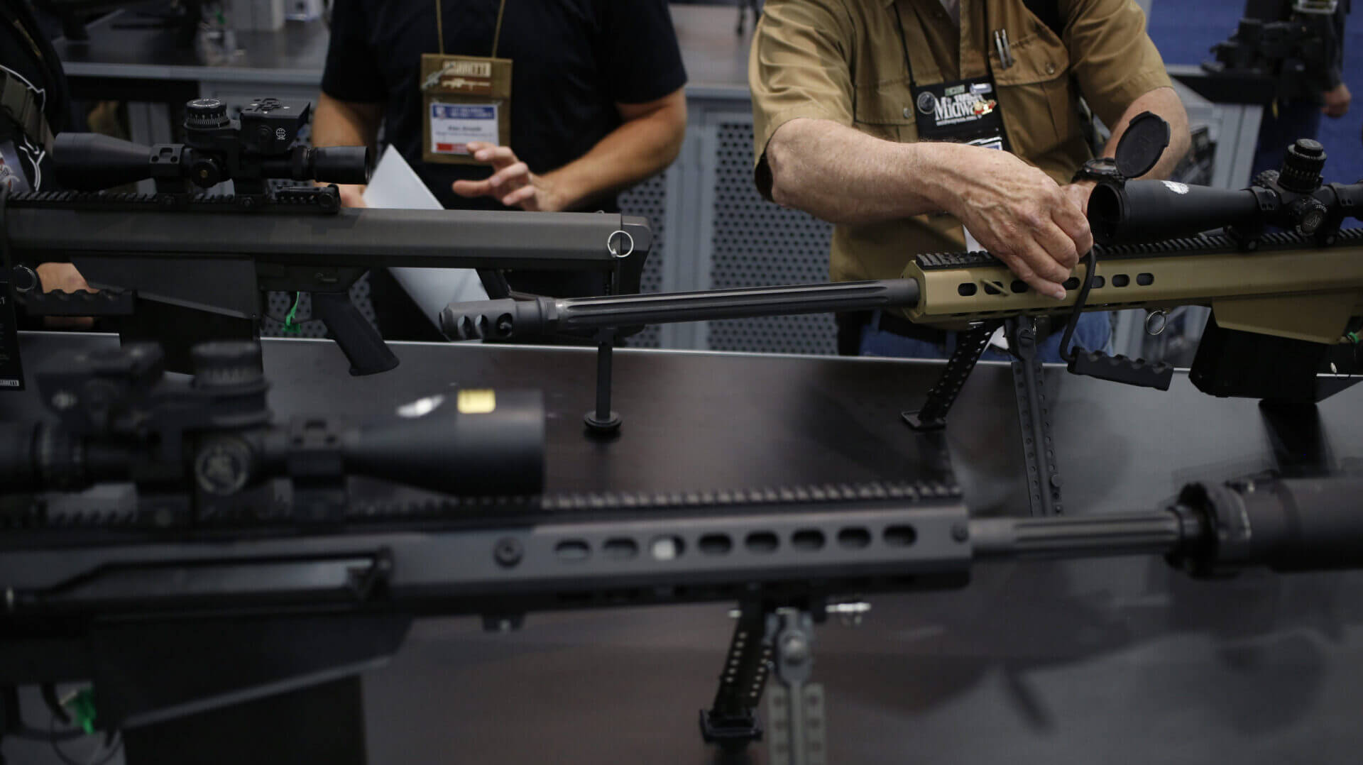 Stock image of high-powered rifles on a gun shop counter with Mexican cartel imagery and federal indictment papers in the foreground