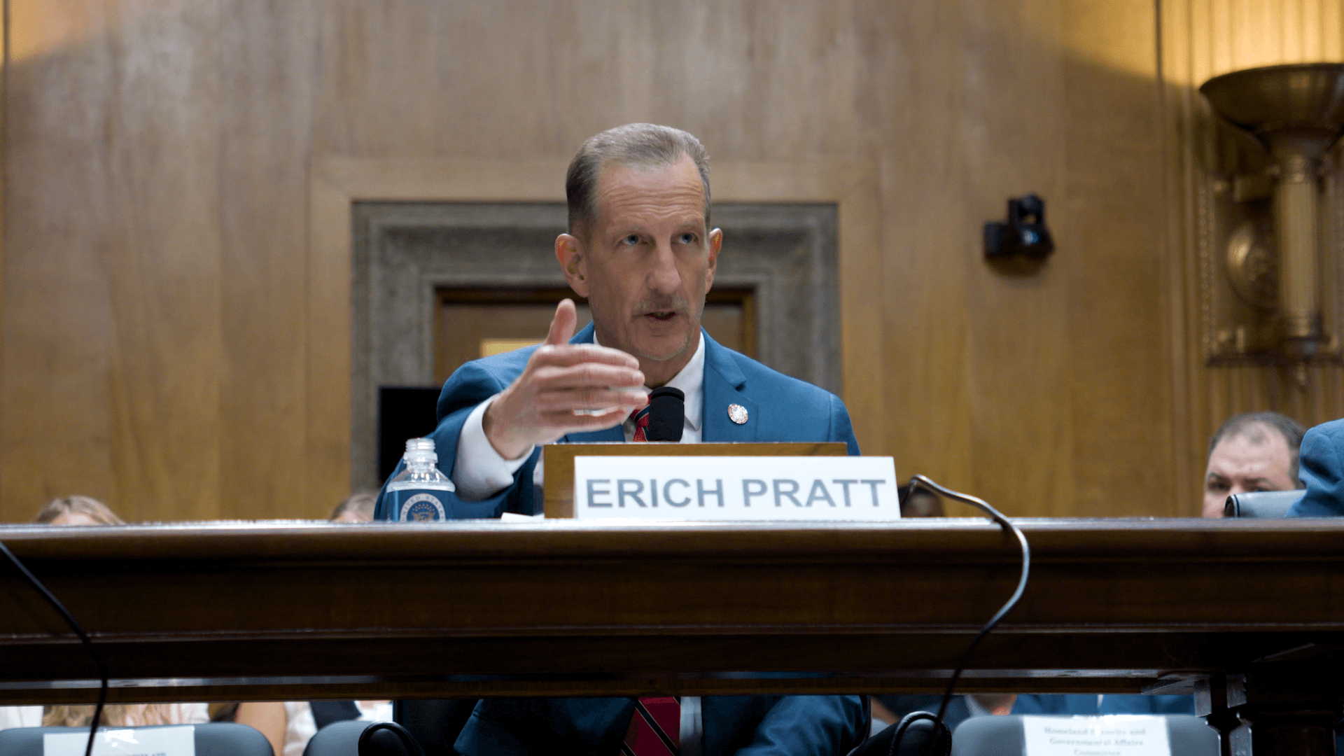 Erich Pratt passionately testifying before the Senate Committee, pointing emphatically at documents exposing the ATF's illegal gun registry.