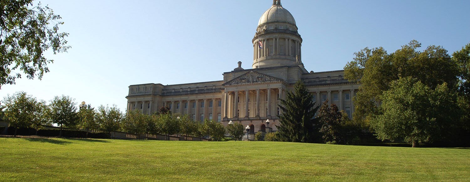 A responsible 19-year-old Kentuckian completing firearms training, holding a concealed carry permit with a handgun holstered safely on their hip.
