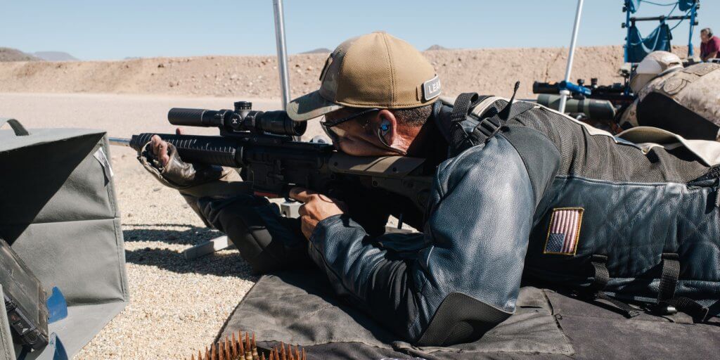 Leapers UTG Integrix 4.5X28 riflescope mounted on an AR-15 service rifle, showcasing its sleek black 34mm tube and illuminated reticle.