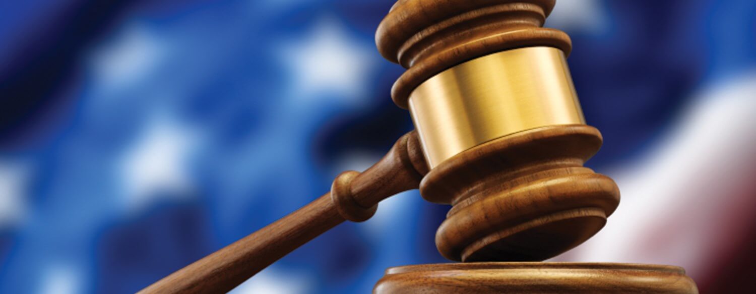 NRA logo overlaid on Virginia state outline with crossed AR-15 rifles and a gavel, symbolizing the lawsuit against assault firearm bans
