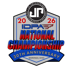 Dynamic action shot of IDPA competitors engaging targets in a realistic defensive scenario at a past National Championship, showcasing speed, accuracy, and precision under pressure.