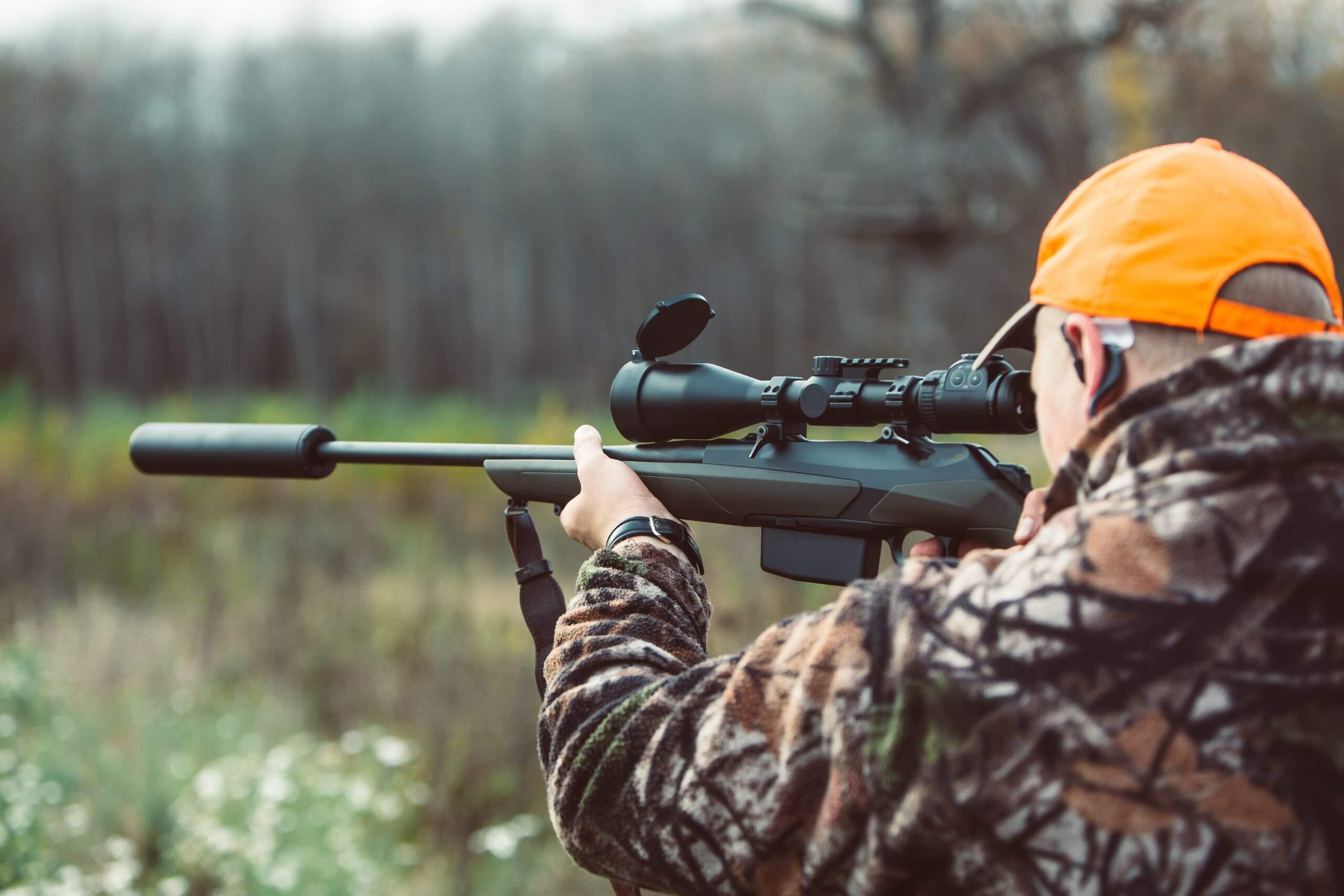 Close-up of a legal NFA suppressor attached to an AR-15 rifle at an Ohio gun range, demonstrating safe and responsible use