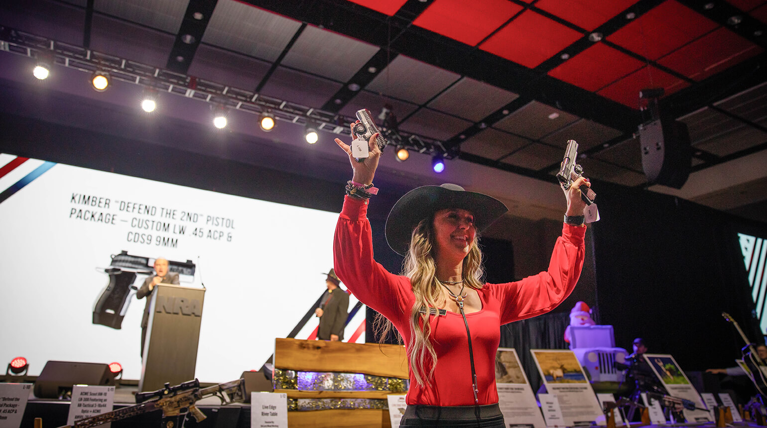 NRA attendees at patriotic events in Houston, including concerts, speeches, and youth shooting demos under American flags.