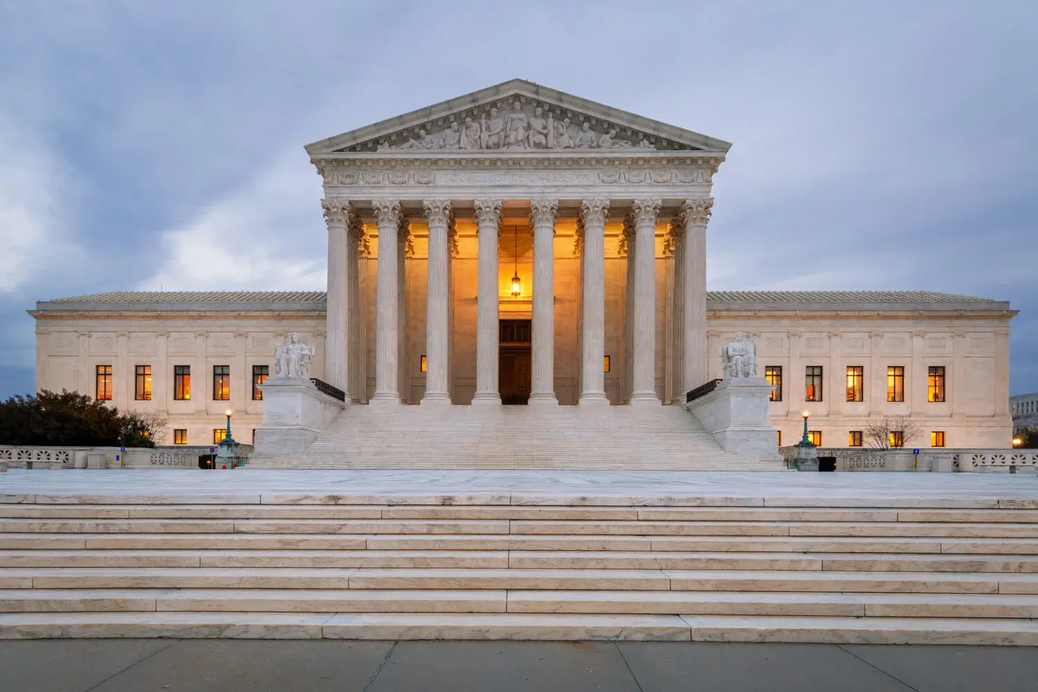 Detailed view of the U.S. Supreme Court building under a clear sky with the Constitution and a modern AR-15 rifle subtly overlaid in the foreground