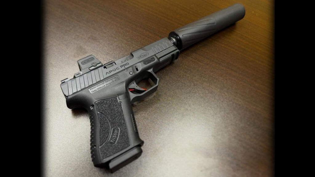 TriStar Arms APOC Pro AR-style semi-automatic shotgun in black finish with modular components displayed on a range table